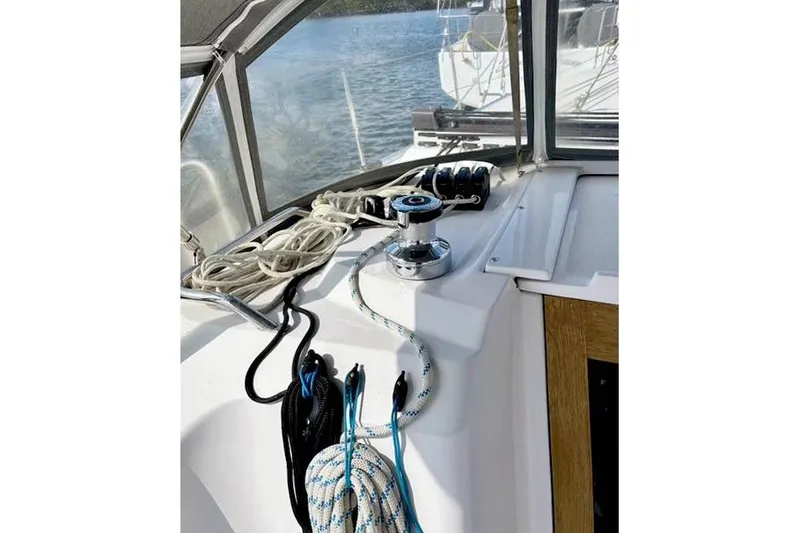 Slide: The Image of 2017 Catalina sailboat cockpit with ropes and winch, overlooking calm water. - 12