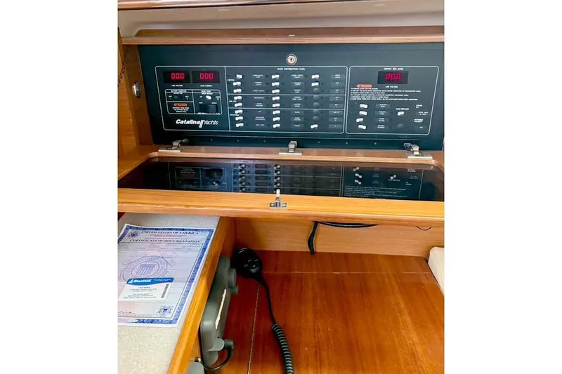 Slide: The Image of 2017 Catalina yacht control panel with navigation equipment and documents. - 18