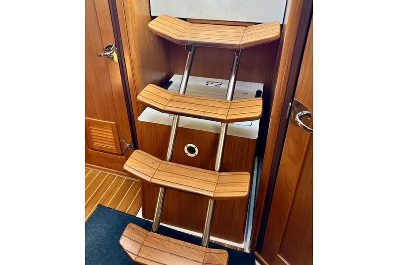 Slide: The Image of Wooden interior stairs on a 2017 Catalina boat, featuring sleek metal supports. - 20