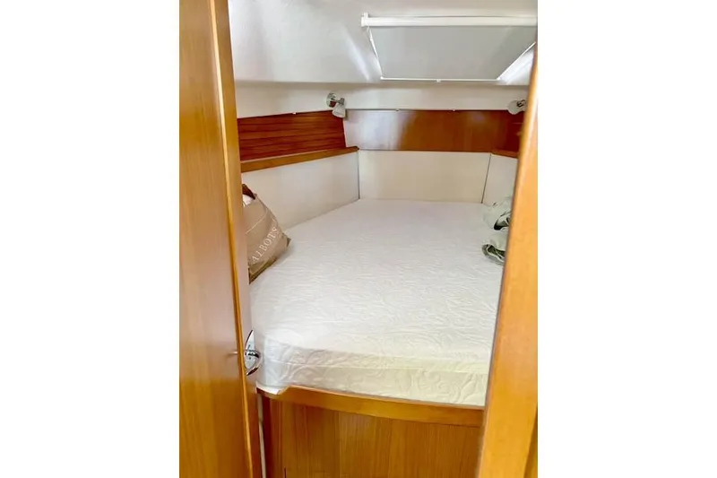 Slide: The Image of 2017 Catalina boat cabin with cozy bed and wooden interior. - 21