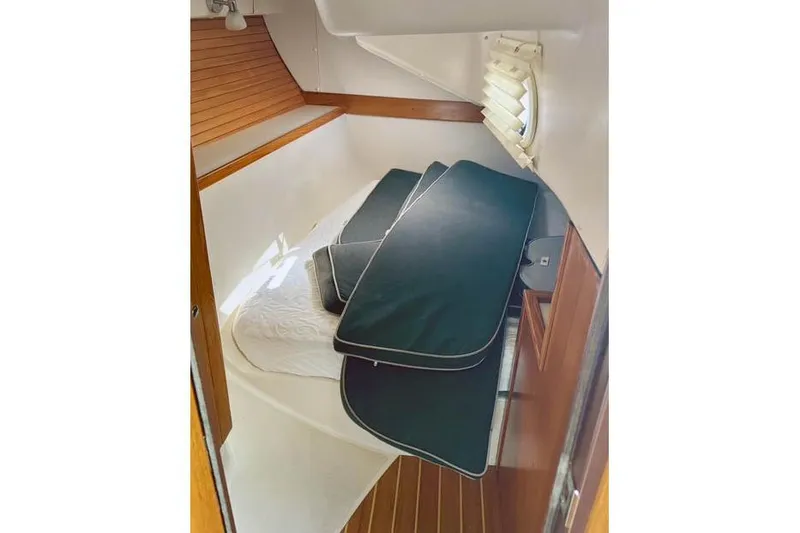 Slide: The Image of 2017 Catalina boat interior cabin with cushions and wooden accents. - 24
