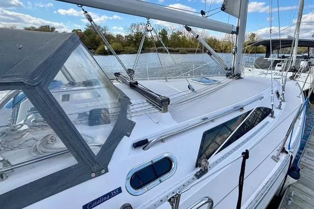Slide: The Image of 2017 Catalina sailboat docked by a serene lake under a blue sky. - 3
