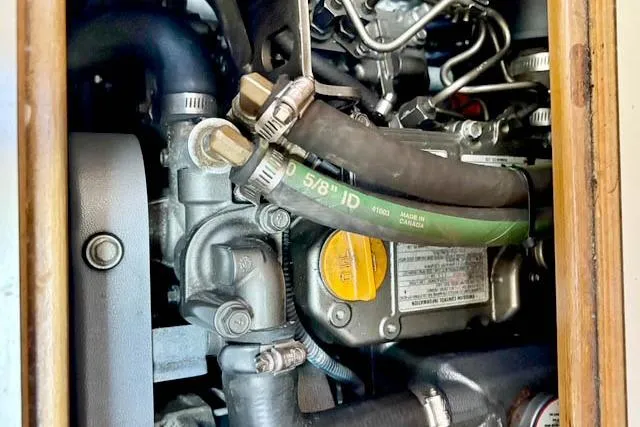 Slide: The Image of Engine compartment of a 2017 Catalina boat, showcasing hoses and mechanical components. - 31