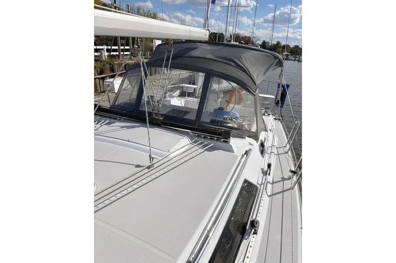 Slide: The Image of 2017 Catalina sailboat with canopy, docked by a scenic waterfront. - 7