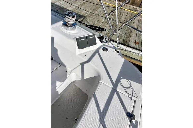 Slide: The Image of 2017 Catalina boat deck with winch and Raymarine equipment, docked at a wooden pier. - 8