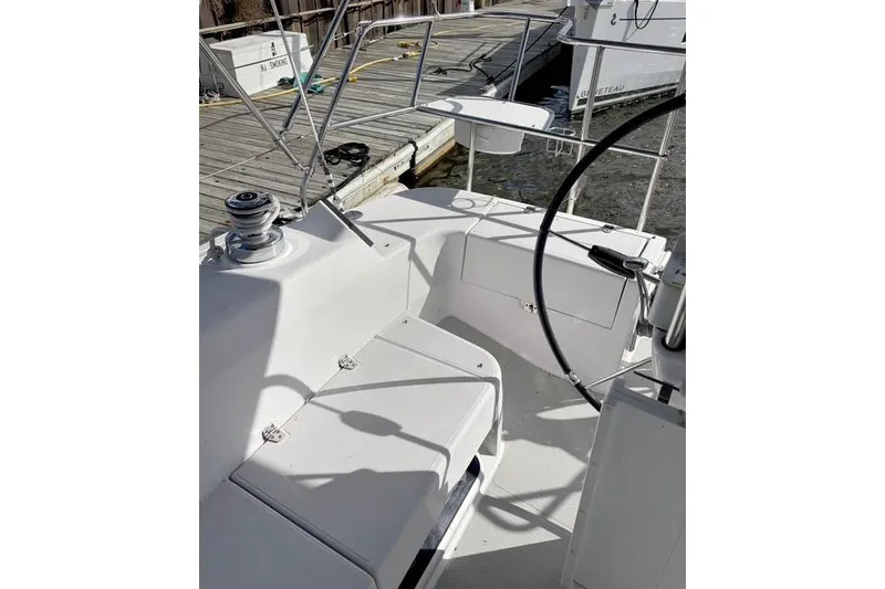 Slide: The Image of 2017 Catalina boat cockpit with steering wheel and dock view. - 9