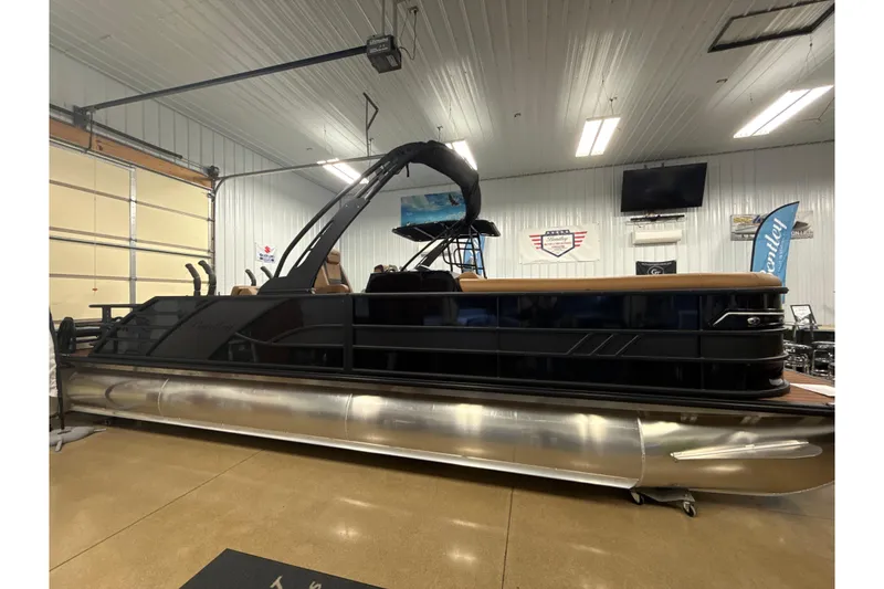 Slide: The Image of 2026 Bentley Pontoons Elite 253 Swingback Dual Capt in showroom, sleek design, modern features. - 0