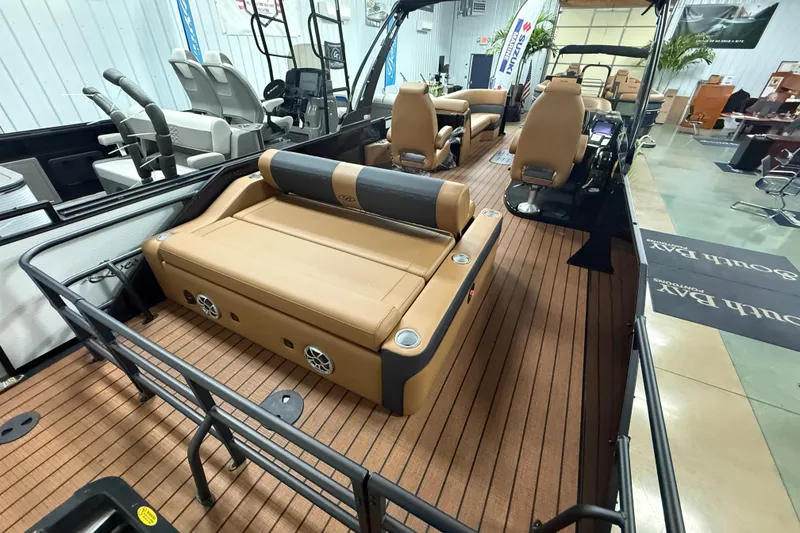 Slide: The Image of 2026 Bentley Pontoons Elite 253 Swingback Dual Capt, luxurious interior with tan seating and wood flooring. - 17