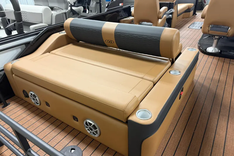 Slide: The Image of 2026 Bentley Pontoons Elite 253 Swingback Dual Capt interior with tan seating and cup holders. - 19