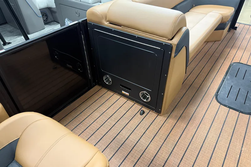 Slide: The Image of 2026 Bentley Pontoons Elite 253 Swingback Dual Capt interior with tan seating and wood-style flooring. - 22