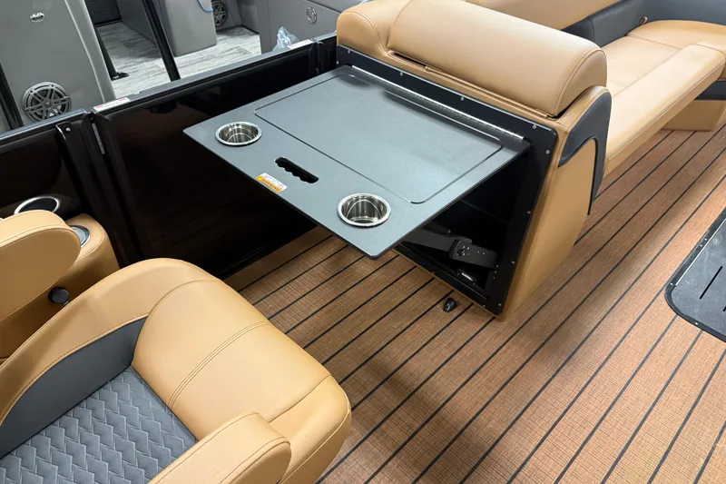 Slide: The Image of 2026 Bentley Pontoons Elite 253 interior with tan seating and foldable table. - 23