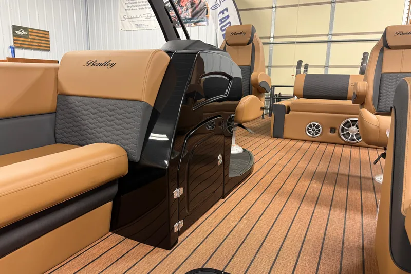 Slide: The Image of 2026 Bentley Pontoons Elite 253 interior with luxurious tan and gray seating, wood-style flooring. - 4