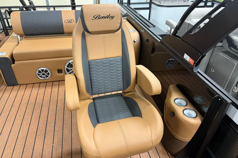 Slide: The Image of 2026 Bentley Pontoons Elite 253 Swingback Dual Capt chair, tan and gray upholstery, luxury design. - 7