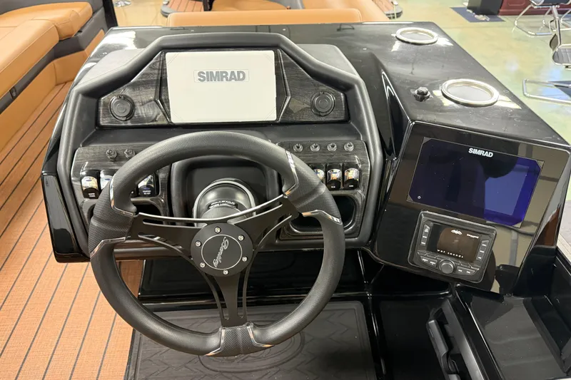 Slide: The Image of 2026 Bentley Pontoons Elite 253 dashboard with Simrad electronics and steering wheel. - 9