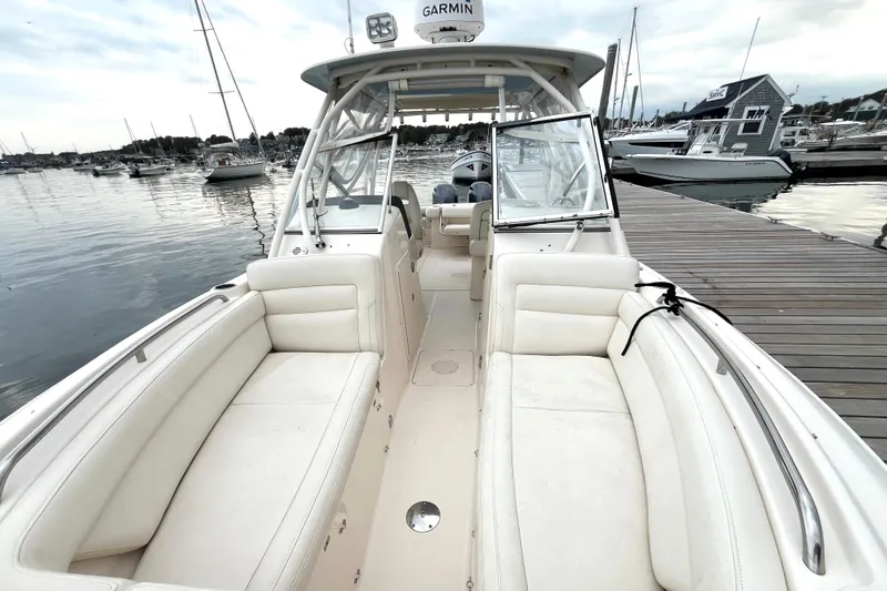 Slide: The Image of 2018 Grady-White Freedom 275 boat docked, featuring spacious seating and Garmin equipment. - 10
