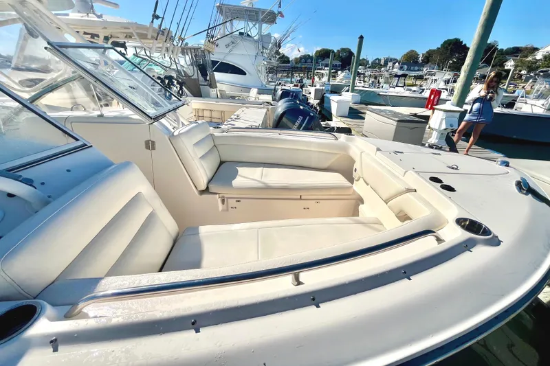 Slide: The Image of 2018 Grady-White Freedom 275 boat with spacious seating at a marina. - 13