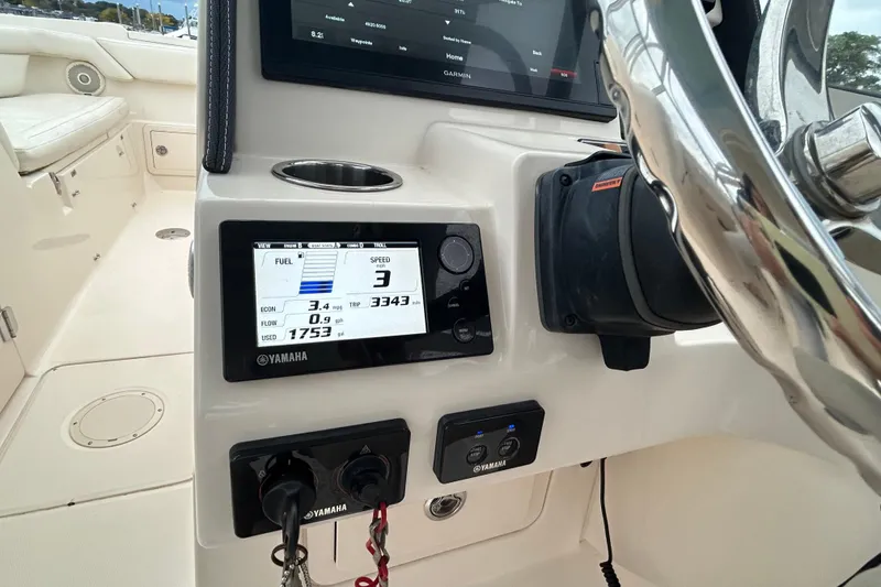 Slide: The Image of 2018 Grady-White Freedom 275 dashboard with Yamaha display and controls. - 16