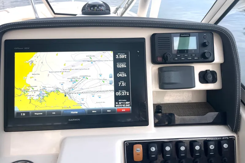 Slide: The Image of Grady-White Freedom 275 dashboard with Garmin GPS and navigation controls, 2018 model. - 21