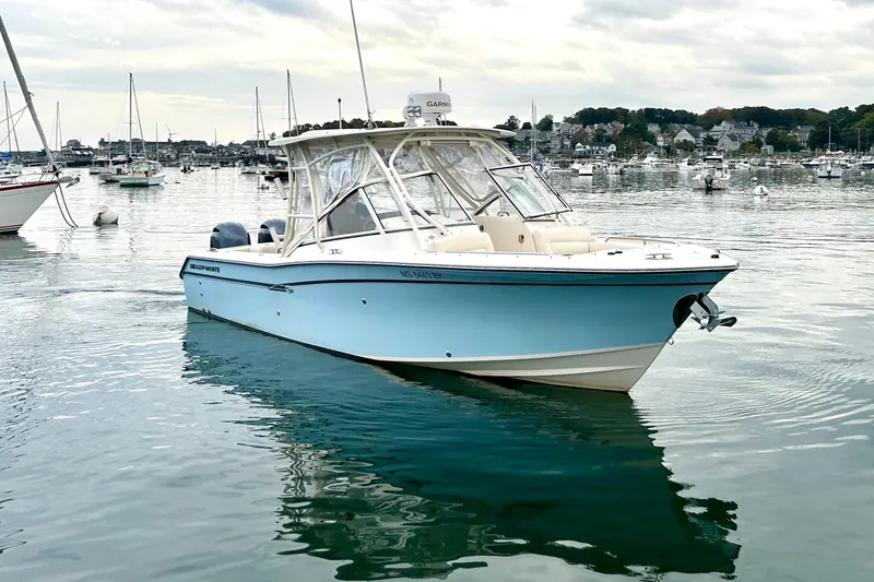 Slide: The Image of 2018 Grady-White Freedom 275 boat on calm water, surrounded by other boats. - 3