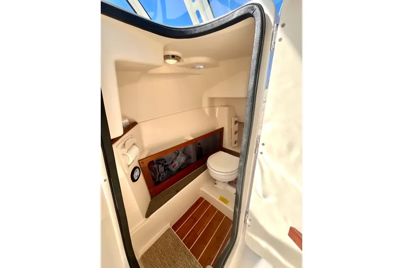 Slide: The Image of 2018 Grady-White Freedom 275 boat interior with compact bathroom amenities. - 33
