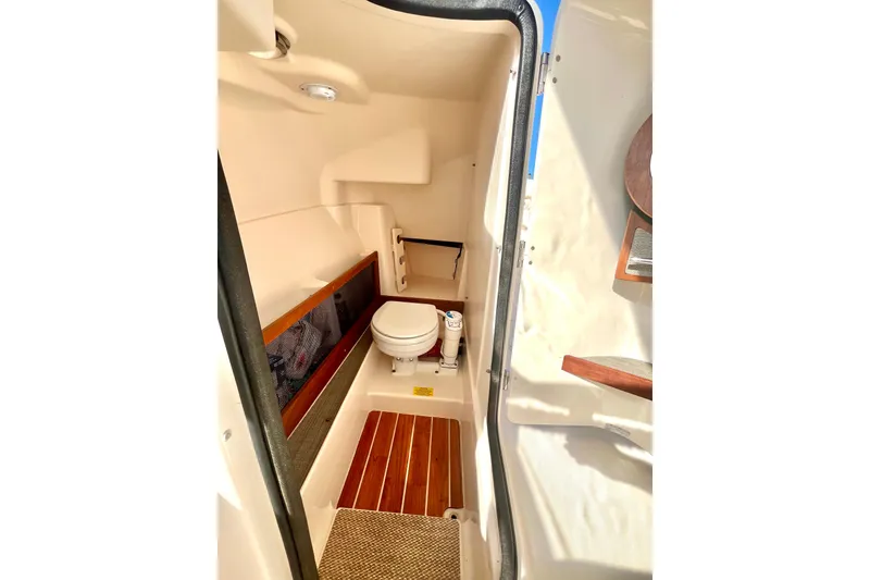 Slide: The Image of 2018 Grady-White Freedom 275 boat interior with compact marine toilet. - 34