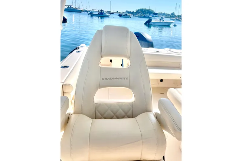 Slide: The Image of Luxurious Grady-White Freedom 275 boat seat, 2018 model, with scenic marina backdrop. - 37