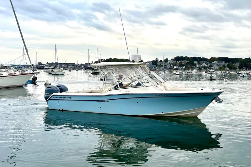 Slide: The Image of 2018 Grady-White Freedom 275 boat on calm water, surrounded by sailboats. - 4