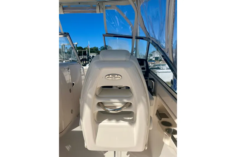 Slide: The Image of 2018 Grady-White Freedom 275 boat interior with helm seat and clear canopy. - 42