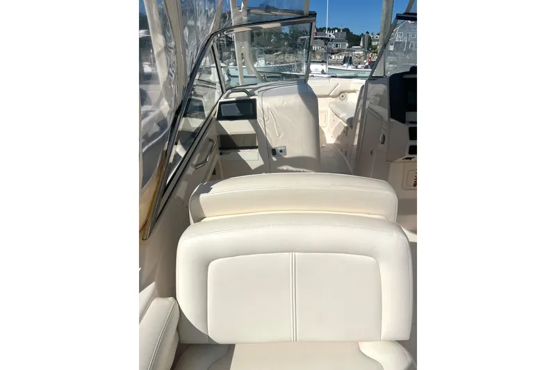 Slide: The Image of 2018 Grady-White Freedom 275 boat interior with white seating and dashboard view. - 45