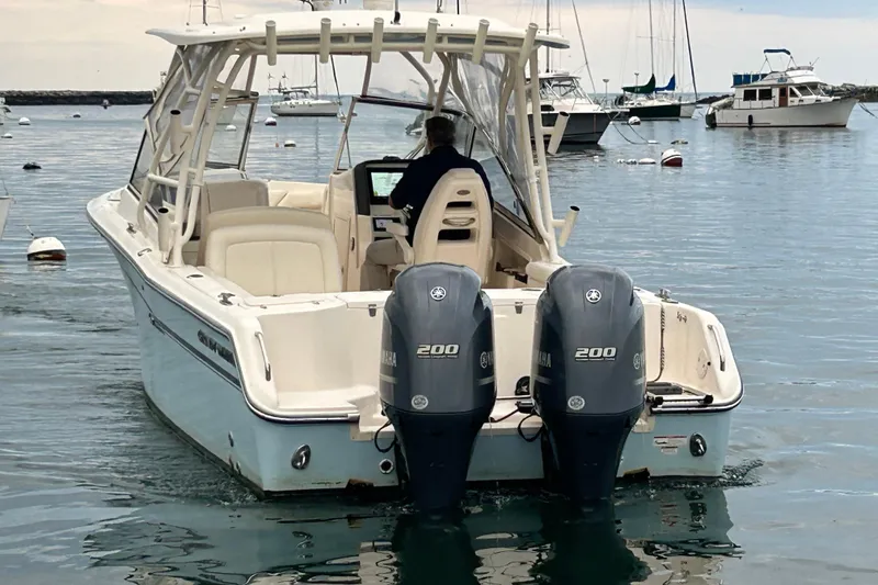 Slide: The Image of 2018 Grady-White Freedom 275 boat with dual Yamaha engines on calm water. - 6