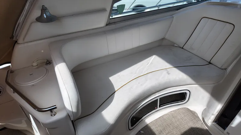Slide: The Image of 2001 Sea Ray 290 Sundancer interior with white seating and built-in cup holder. - 11