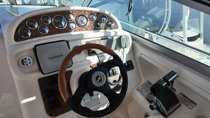 Slide: The Image of 2001 Sea Ray 290 Sundancer helm with Garmin GPS and wood-accented dashboard. - 13