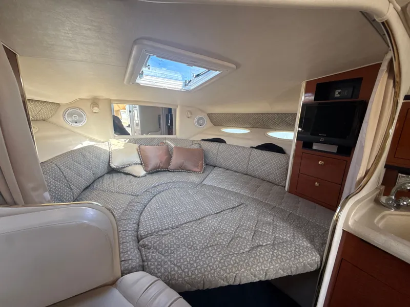 Slide: The Image of Interior of 2001 Sea Ray 290 Sundancer with cozy seating and modern amenities. - 19