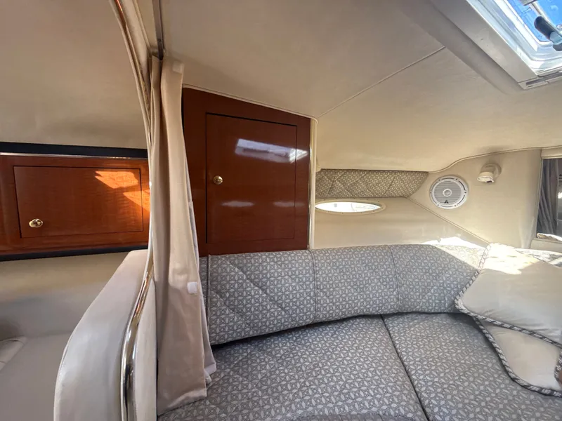 Slide: The Image of Interior cabin of 2001 Sea Ray 290 Sundancer with cozy seating and wooden cabinetry. - 24