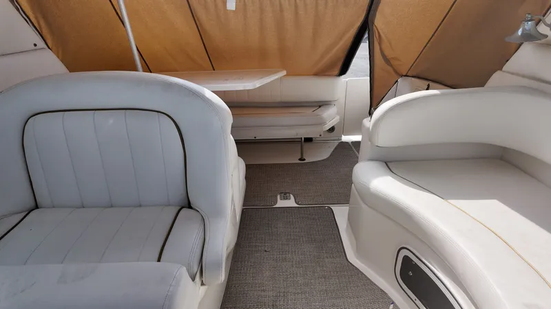 Slide: The Image of Interior of 2001 Sea Ray 290 Sundancer boat with white seating and table. - 3