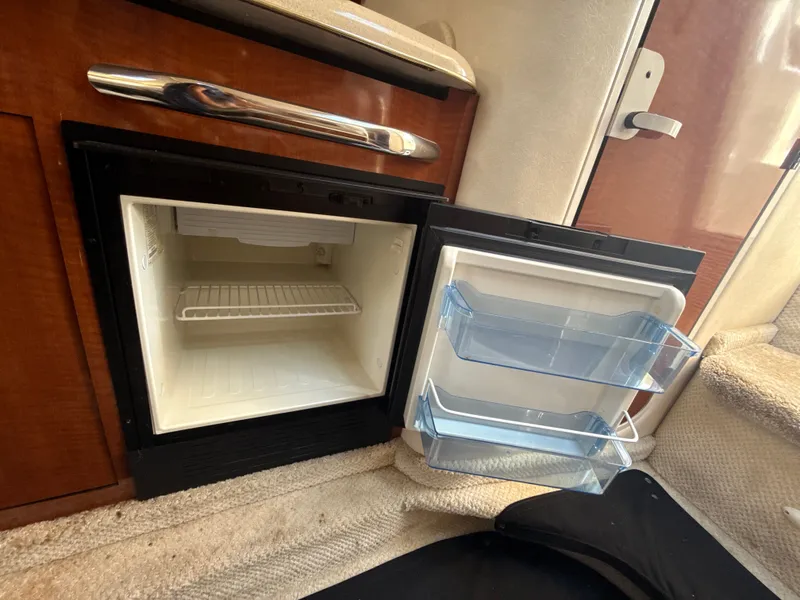 Slide: The Image of Open mini fridge inside 2001 Sea Ray 290 Sundancer boat cabin. - 34