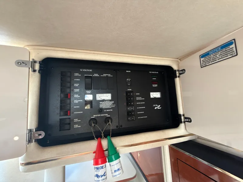 Slide: The Image of Electrical panel of 2001 Sea Ray 290 Sundancer boat, featuring various switches and controls. - 35