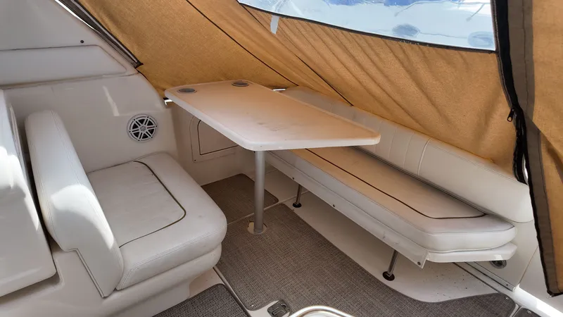 Slide: The Image of Interior of 2001 Sea Ray 290 Sundancer with seating and table under a canopy. - 5