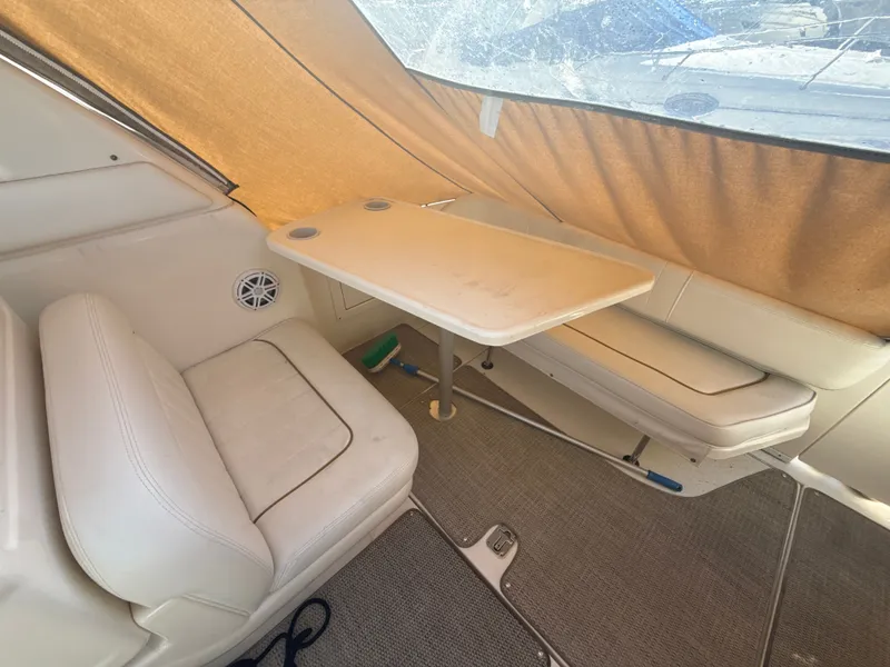 Slide: The Image of Interior of 2001 Sea Ray 290 Sundancer boat with seating and table setup. - 6