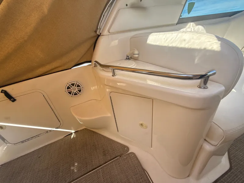 Slide: The Image of 2001 Sea Ray 290 Sundancer interior with seating, storage, and speaker. - 7
