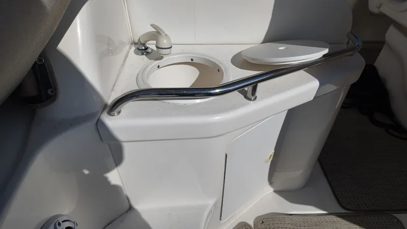 Slide: The Image of 2001 Sea Ray 290 Sundancer boat sink area with faucet and cover. - 8