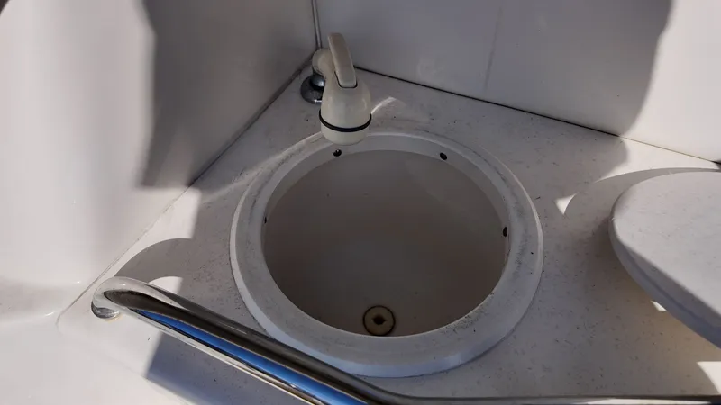 Slide: The Image of 2001 Sea Ray 290 Sundancer boat sink with faucet and railing. - 9