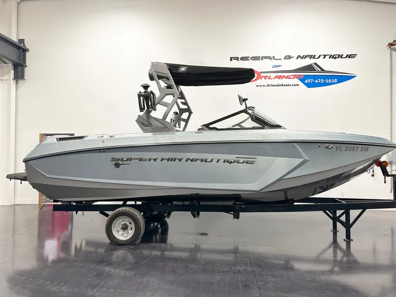 The Image of 2020 Nautique Super Air G23 boat on trailer in showroom. - 1