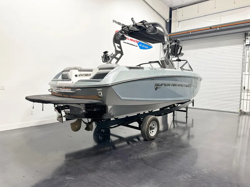 Slide: The Image of 2020 Nautique Super Air G23 boat in a showroom on a trailer. - 4