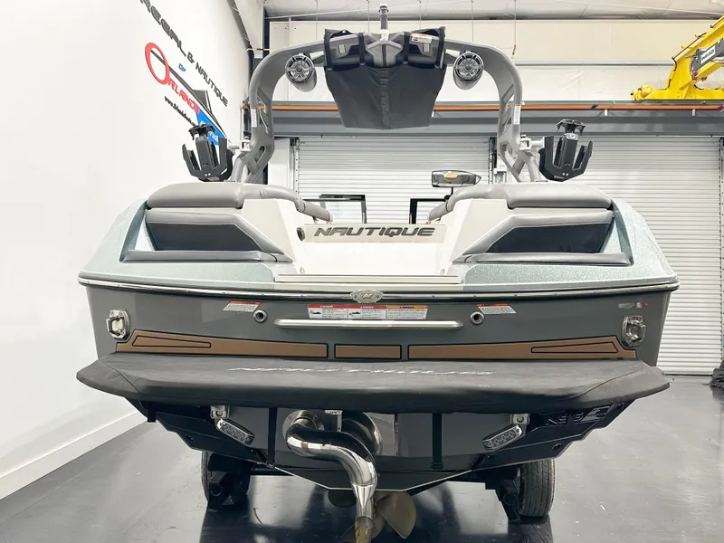 Slide: The Image of 2020 Nautique Super Air G23 boat, rear view in a showroom setting. - 5