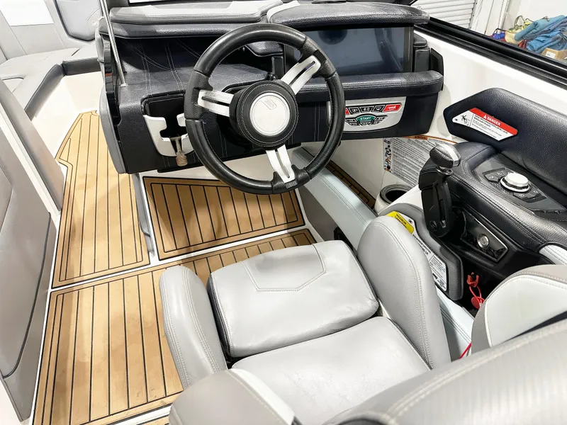 Slide: The Image of 2020 Nautique Super Air G23 boat interior with steering wheel and control panel. - 8