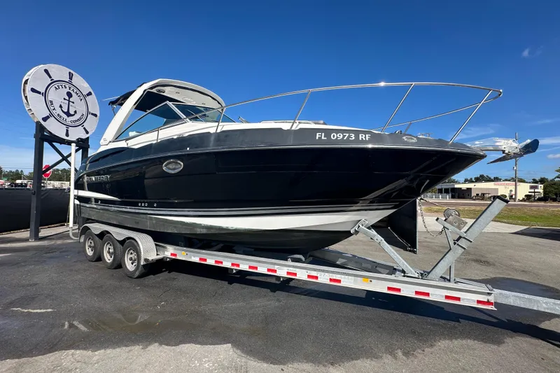 The Image of 2016 Monterey 295 Sport Yacht on trailer under clear blue sky. - 0