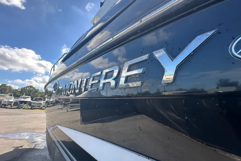 Slide: The Image of 2016 Monterey 295 Sport Yacht rear view with propeller and trailer. - 10