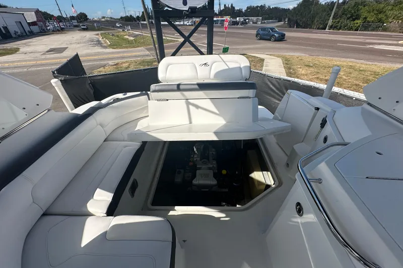 Slide: The Image of 2016 Monterey 295 Sport Yacht interior with white seating and outdoor view. - 100