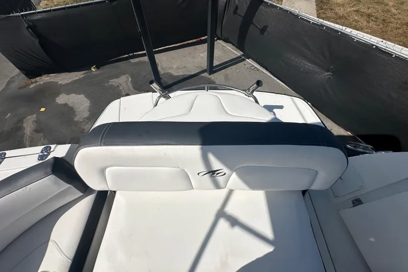 Slide: The Image of 2016 Monterey 295 Sport Yacht interior with white seating and storage compartment. - 106